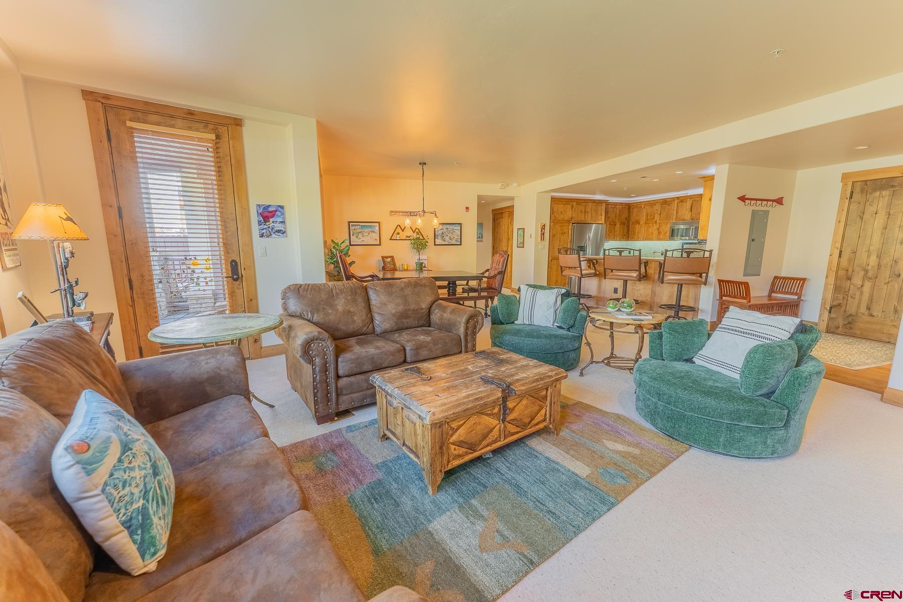 14 Hunter Hill Road, Unit A208 Crested Butte, CO 81225 - Photo 4 of 35 a living room with furniture and a large window