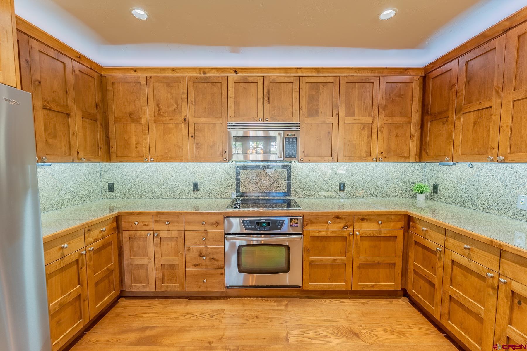 14 Hunter Hill Road, Unit A208 Crested Butte, CO 81225 - Photo 7 of 35 a kitchen with stainless steel appliances granite countertop a stove and a refrigerator