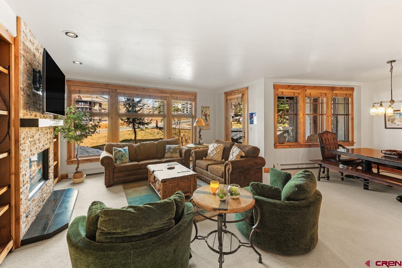 14 Hunter Hill Road, Unit A208 Crested Butte, CO 81225 - Photo 8 of 43 a living room with fireplace furniture and a large window