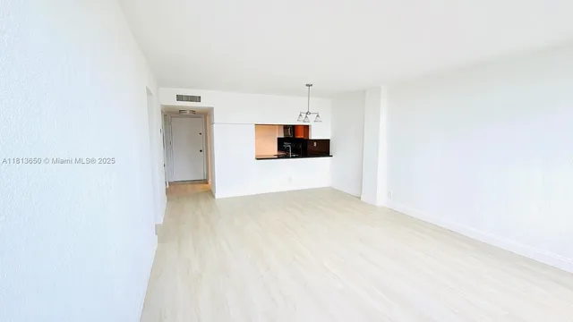 a view of a room with a kitchen and a sink
