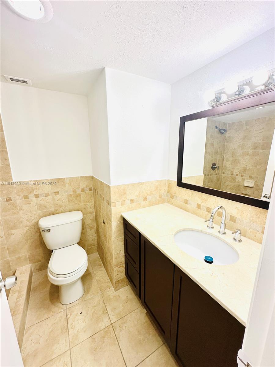 9001 Southwest 77th Avenue, Unit C608 Miami, FL 33156 - Photo 14 of 15 a bathroom with a sink and a mirror