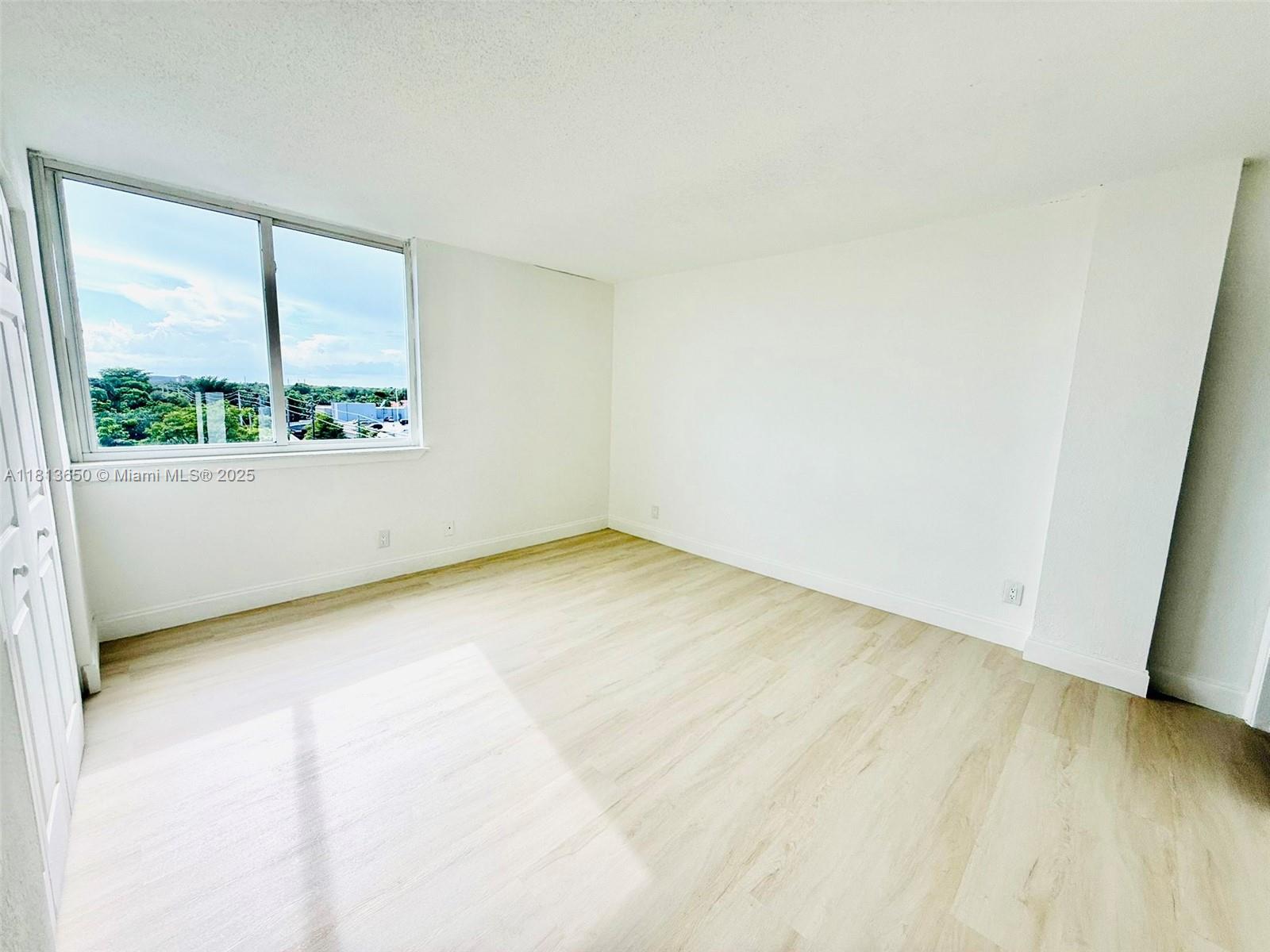 9001 Southwest 77th Avenue, Unit C608 Miami, FL 33156 - Photo 15 of 15 an empty room with a window