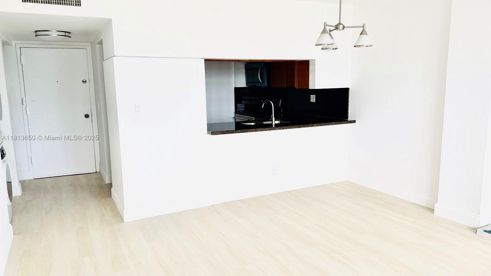 9001 Southwest 77th Avenue, Unit C608 Miami, FL 33156 - Photo 4 of 15 a living room with furniture and a flat screen tv