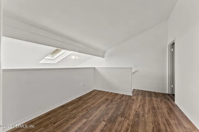 a view of a room with wooden floor