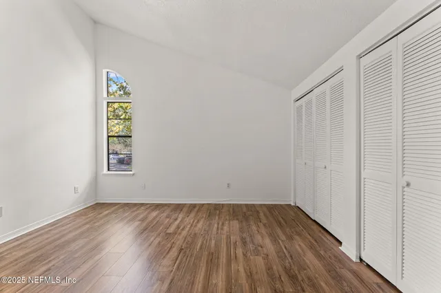 a view of room with window and hardwood floor