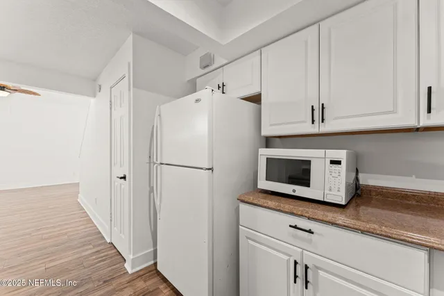 a white refrigerator freezer sitting inside of a kitchen