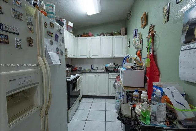 a kitchen with stainless steel appliances a stove a sink and a refrigerator