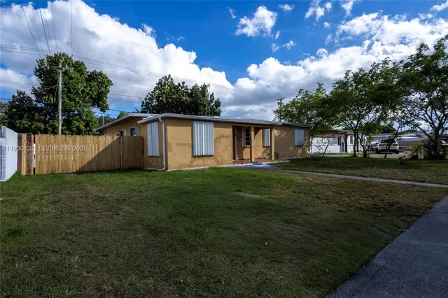 a view of house with backyard
