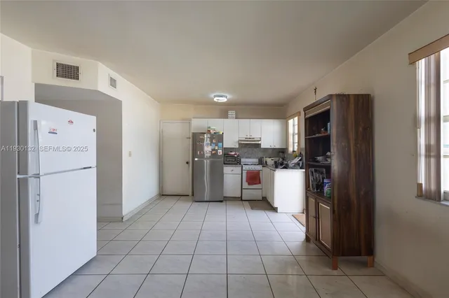a kitchen with stainless steel appliances a refrigerator sink and cabinets