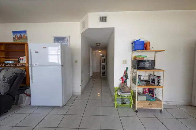 a living room with furniture and a book shelf