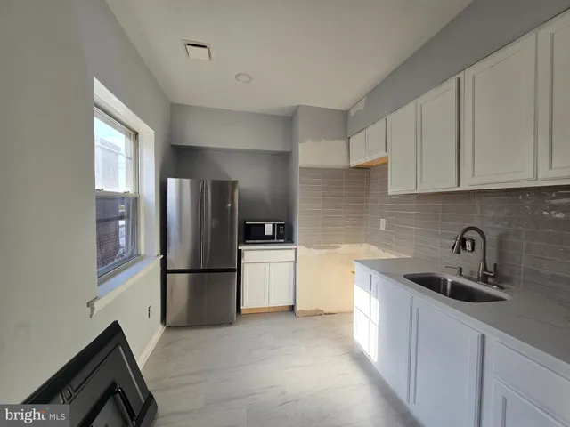 a bathroom with a sink and mirror with toilet