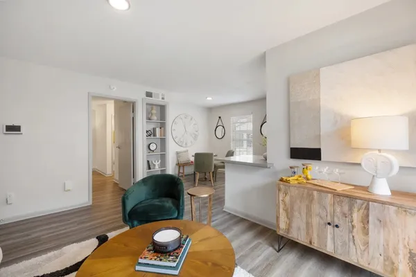 a living room with furniture and wooden floor
