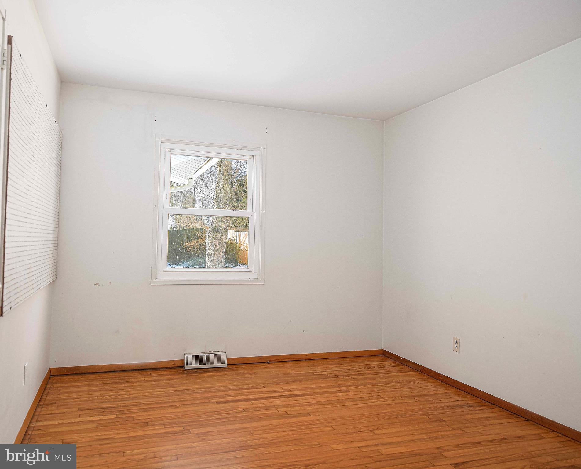 103 Chatham Road Bel Air, MD 21014 - Photo 11 of 21 a view of an empty room with wooden floor and a window