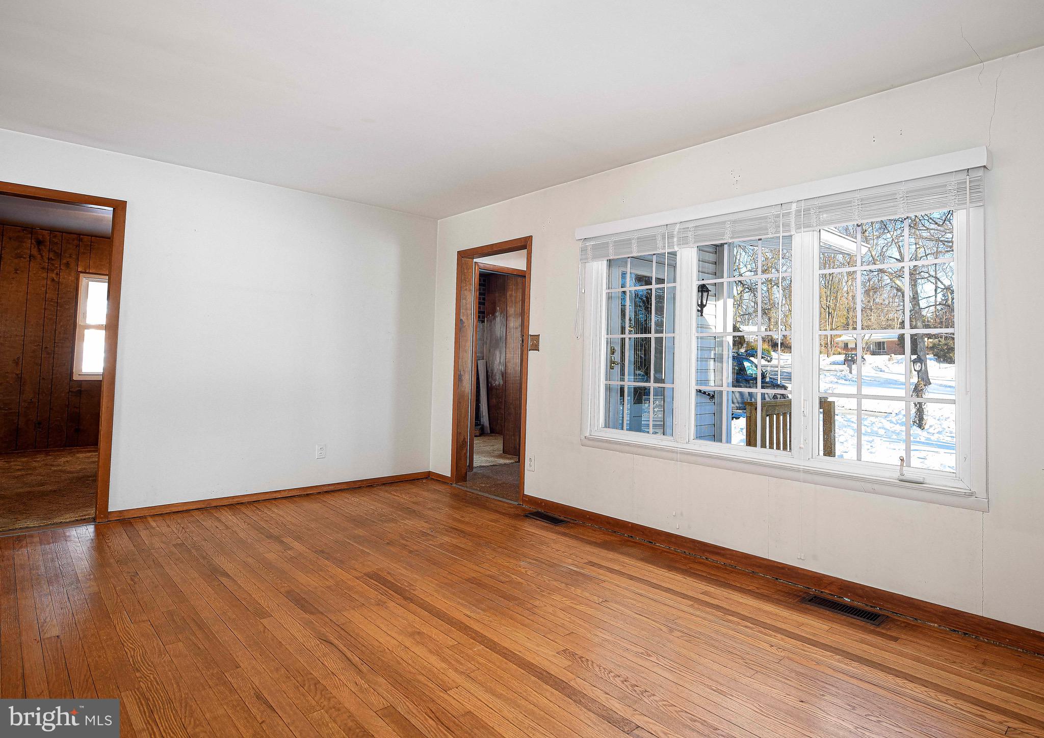 103 Chatham Road Bel Air, MD 21014 - Photo 3 of 21 a view of an empty room with wooden floor and a window