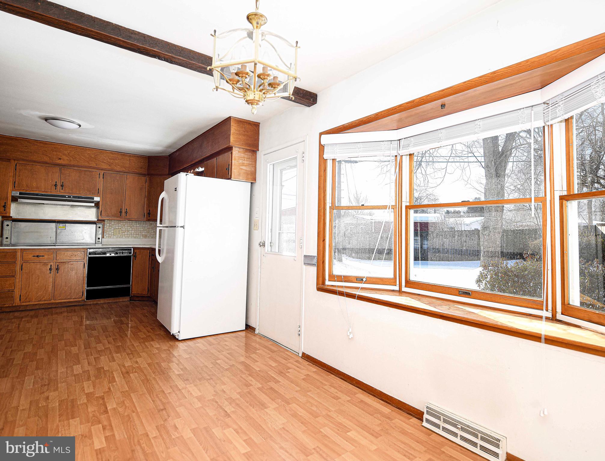 103 Chatham Road Bel Air, MD 21014 - Photo 5 of 21 a view of a kitchen with a fridge and an empty room