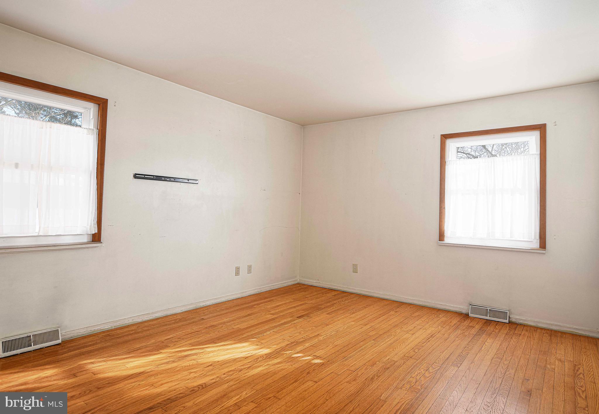 103 Chatham Road Bel Air, MD 21014 - Photo 10 of 21 an empty room with wooden floor and windows