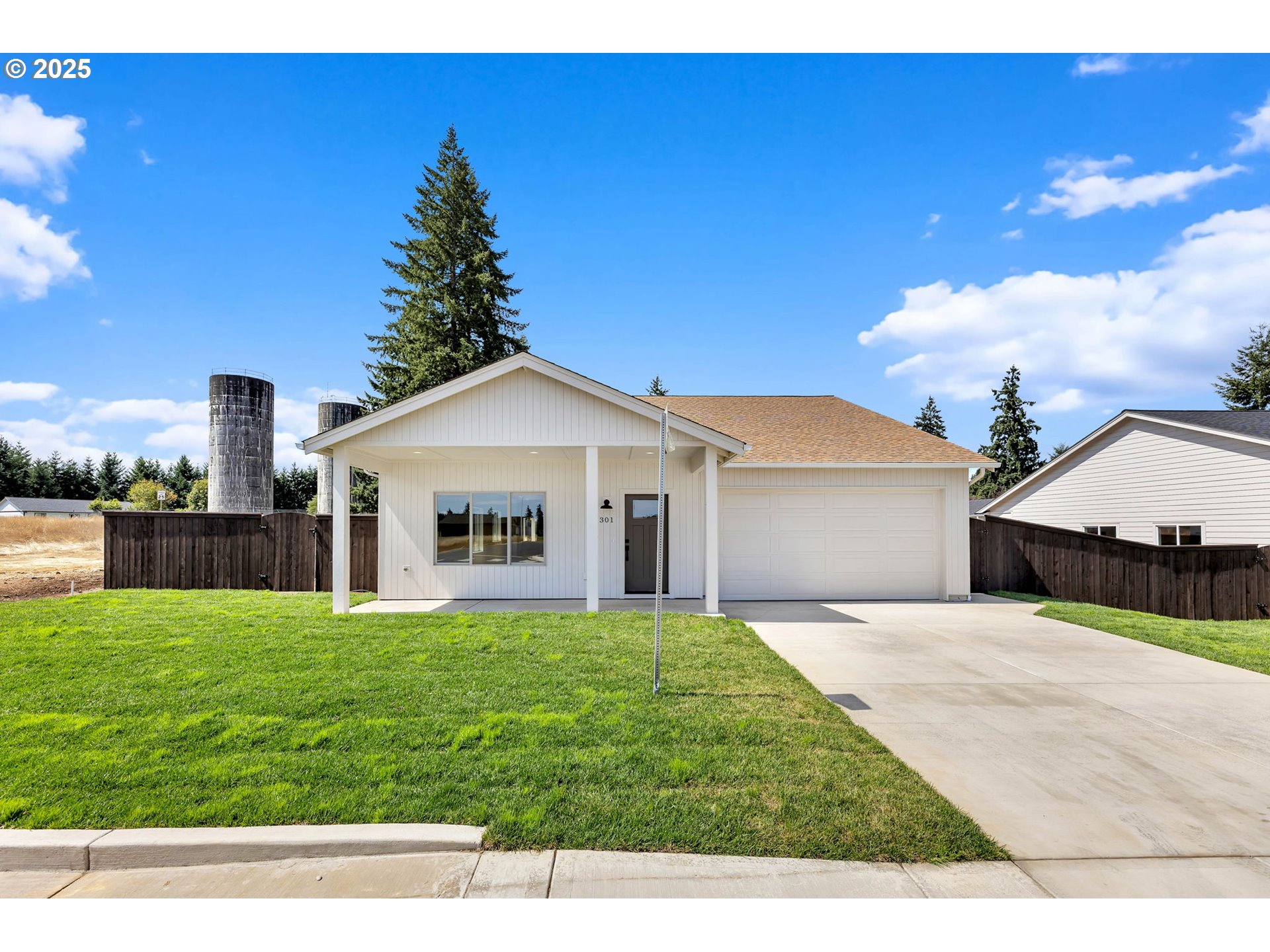 a view of a house with a yard and a garage