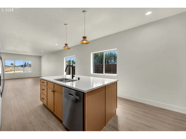 a kitchen with a sink and wooden floor