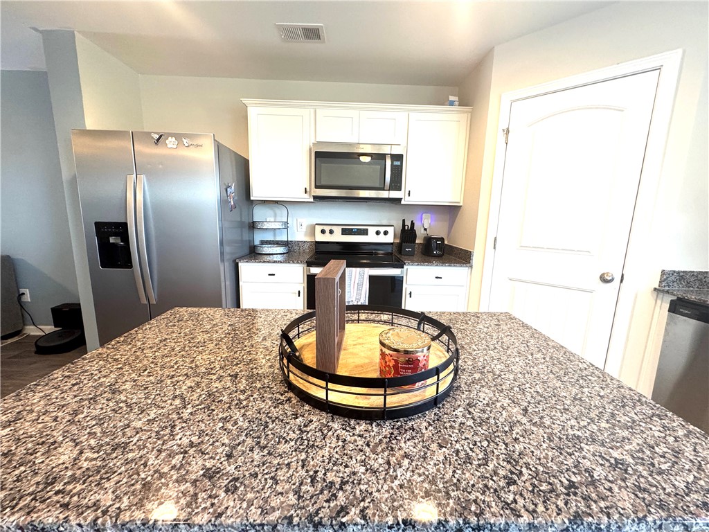 143 Adger Road Pendleton, SC 29670 - Photo 14 of 30 Polished granite countertops and classic white cabinetry define this functional kitchen space.