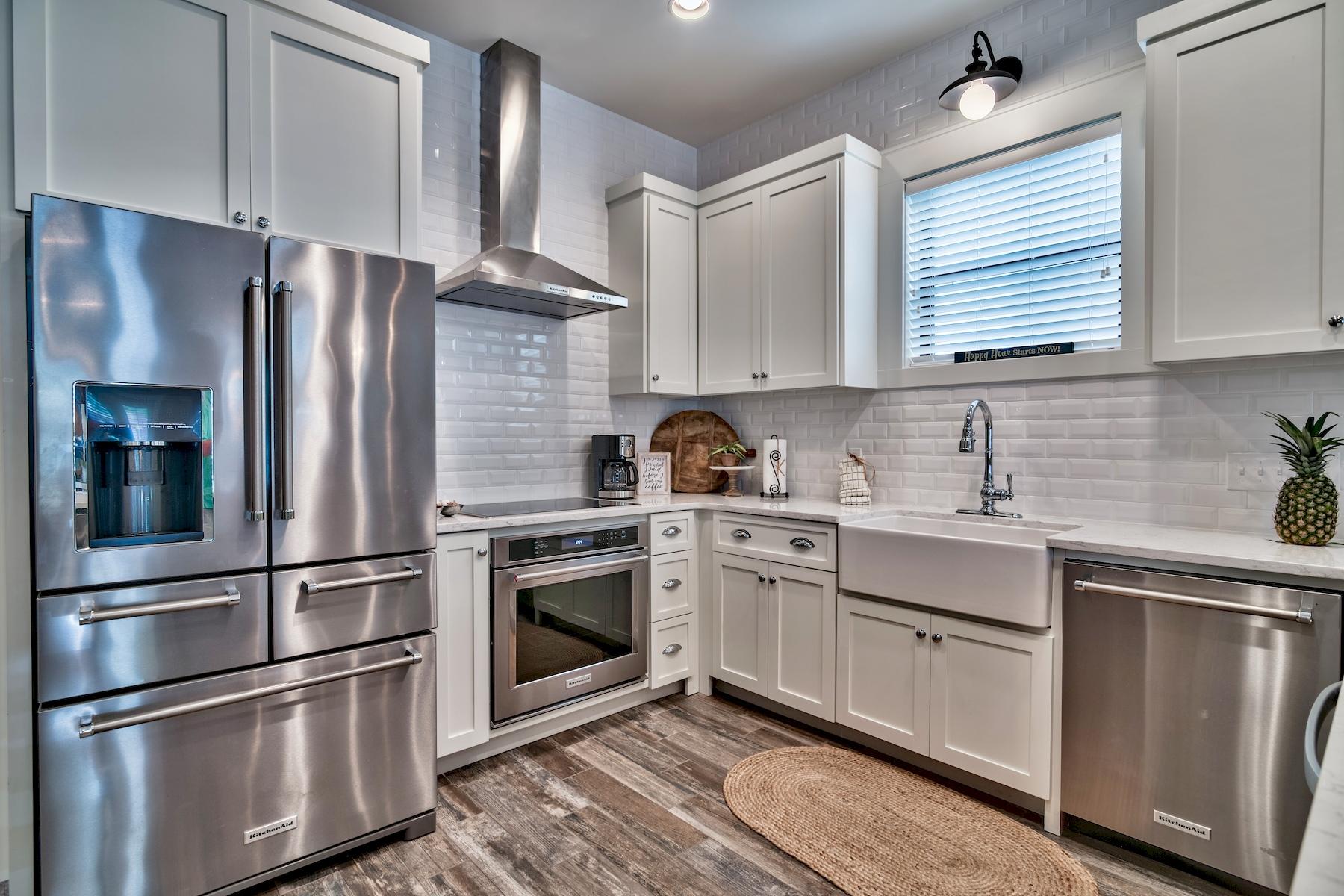 33 West Seacrest Beach Blvd Inlet Beach Inlet Beach, FL 32461 - Photo 4 of 53 a kitchen with stainless steel appliances kitchen island granite countertop a refrigerator stove and sink