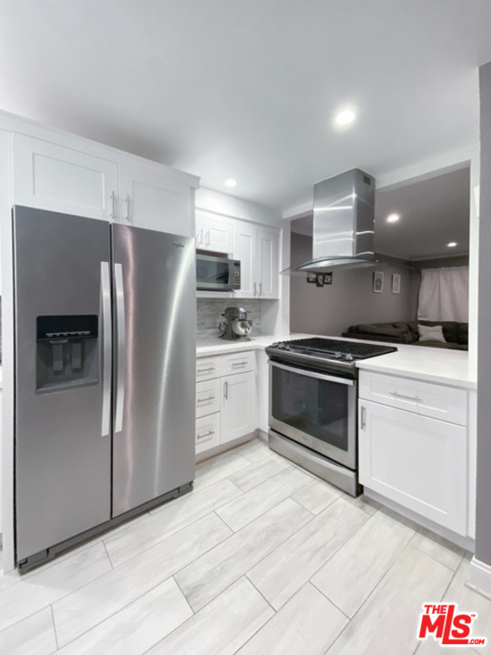 a kitchen with a refrigerator stove and microwave