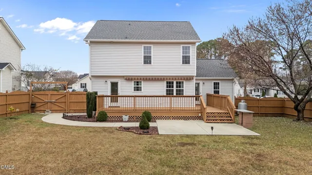 a view of a house with pool and chairs