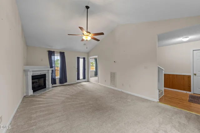 a view of an empty room with a fireplace
