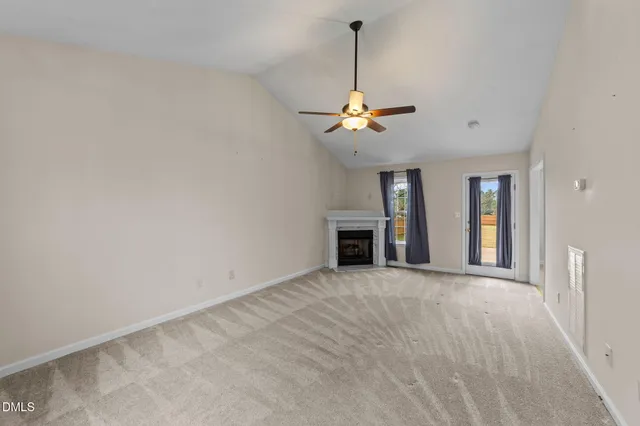 a view of an empty room with a fireplace