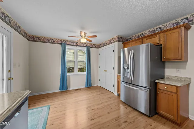 a kitchen with stainless steel appliances granite countertop a refrigerator and a sink