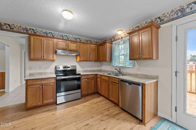 a kitchen with stainless steel appliances granite countertop a stove and a sink