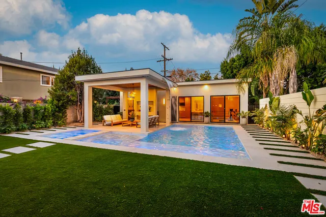 a living room with furniture and large windows