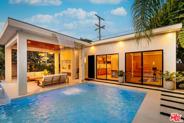 a living room with furniture a rug and a large window