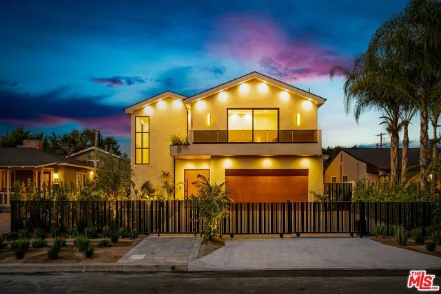 a living room with fireplace furniture and a large window