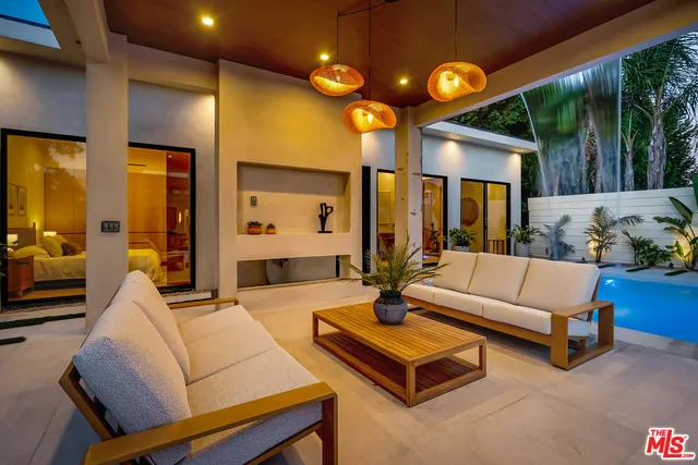 a bedroom with a bed and a dresser with wooden floor