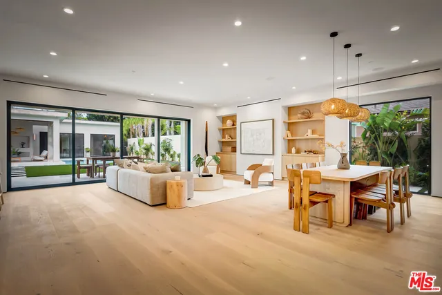 a kitchen with appliances cabinets and chair