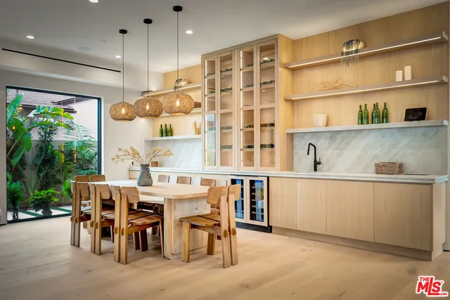 a living room with furniture and large windows