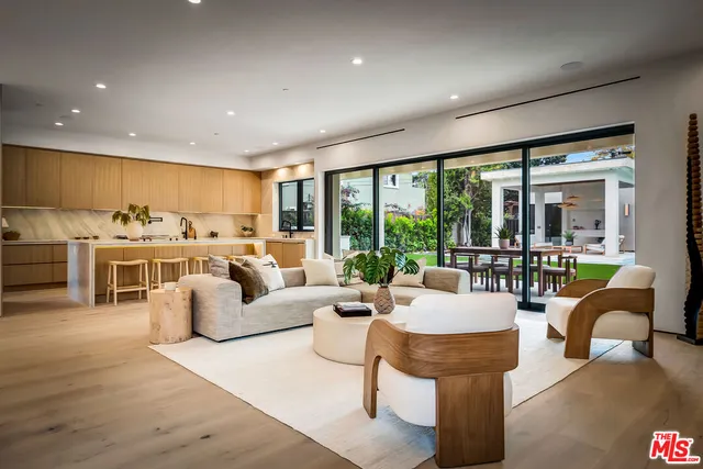a living room with furniture and kitchen view