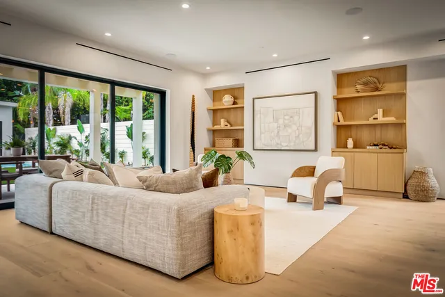 a front view of a house with a yard and potted plants