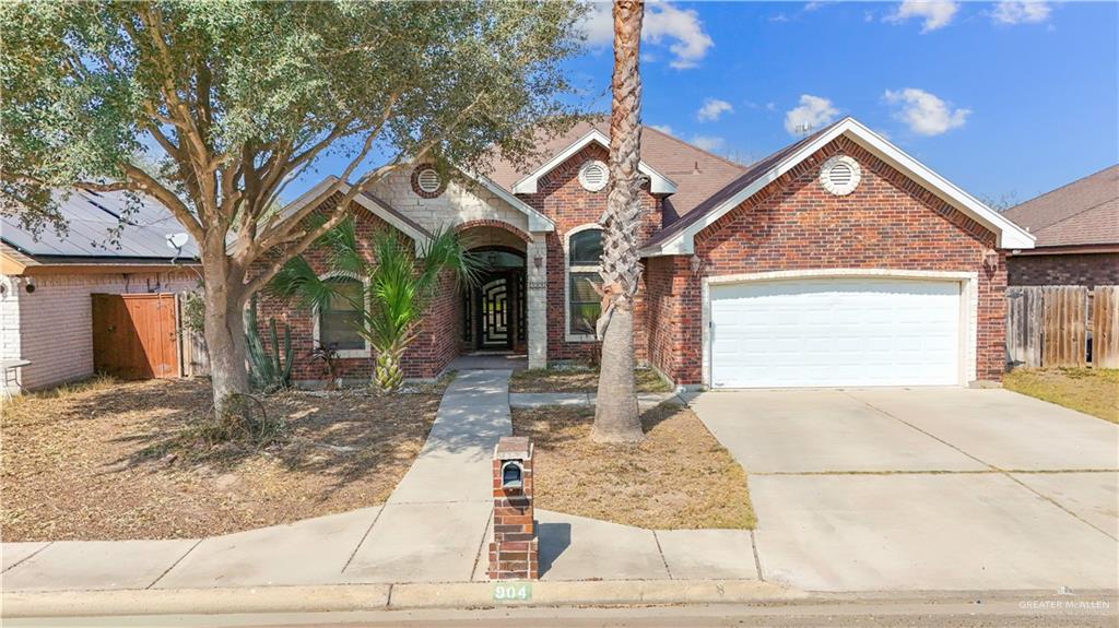 904 West E Street Mission, TX 78572 - Photo 1 of 1 a view of a house with a yard and garage