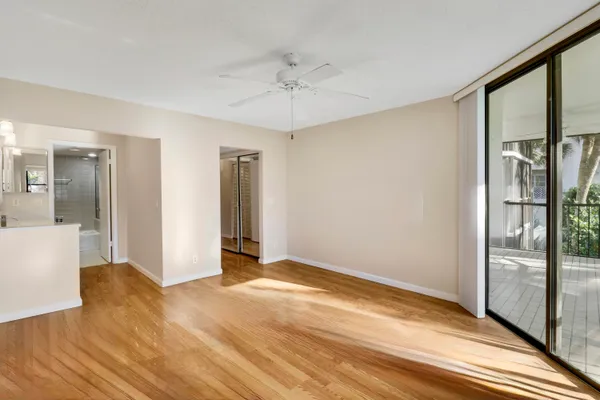 a view of a room with wooden floor fireplace and windows