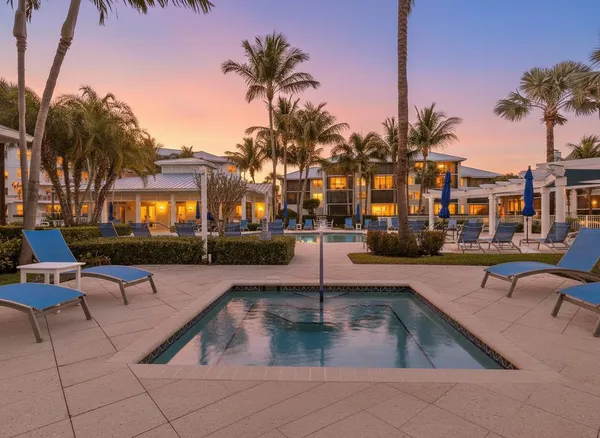 a view of a patio with dining table and chairs