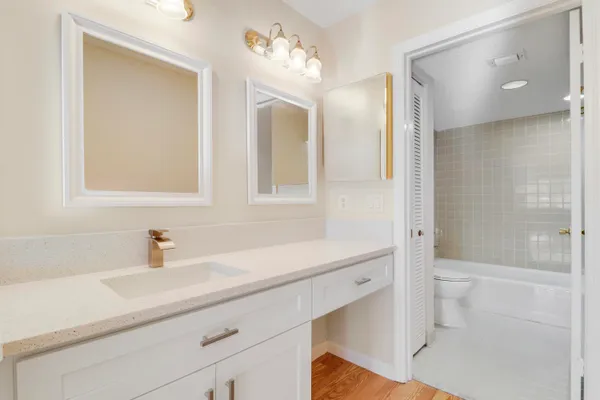 a bedroom with a large bed and a flat tv screen