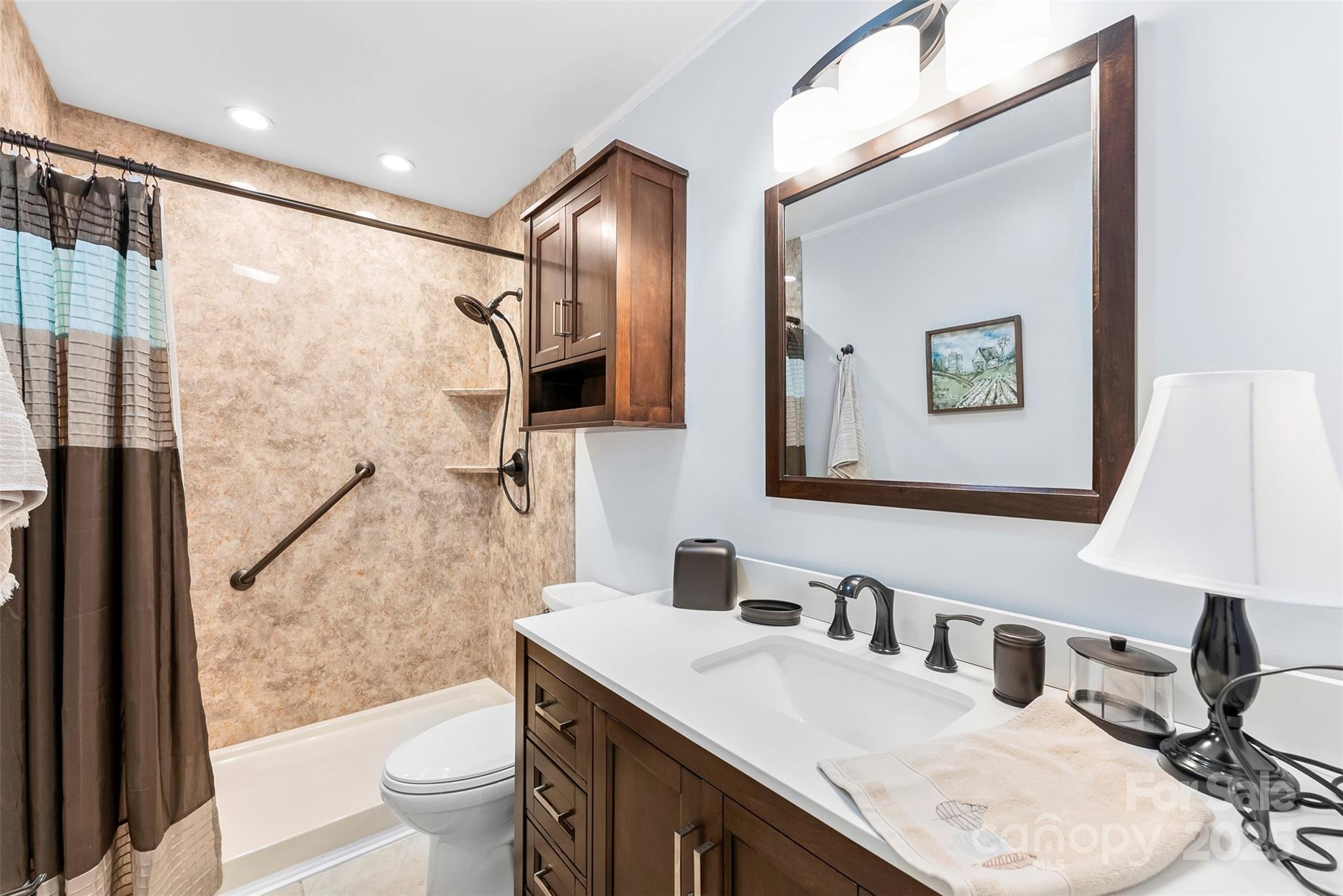 213 Press Sweezy Road Kings Mountain, NC 28086 - Photo 11 of 43 a bathroom with a granite countertop sink a toilet a mirror and shower
