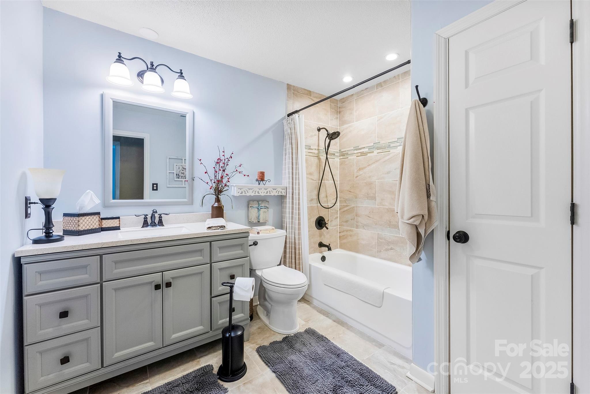 213 Press Sweezy Road Kings Mountain, NC 28086 - Photo 12 of 43 a bathroom with a double vanity sink toilet mirror and bathtub