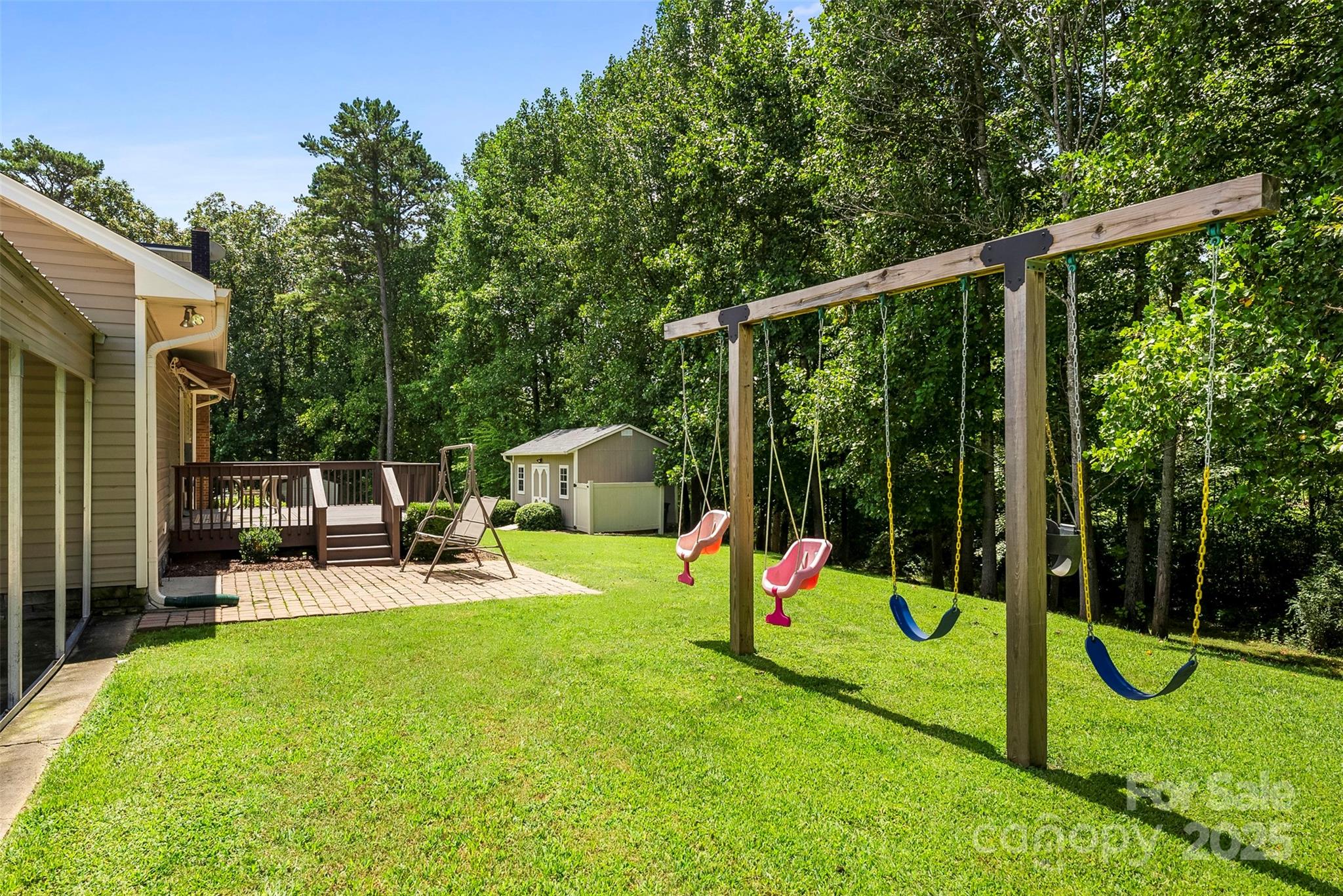 213 Press Sweezy Road Kings Mountain, NC 28086 - Photo 33 of 43 a view of a backyard with swings and slides