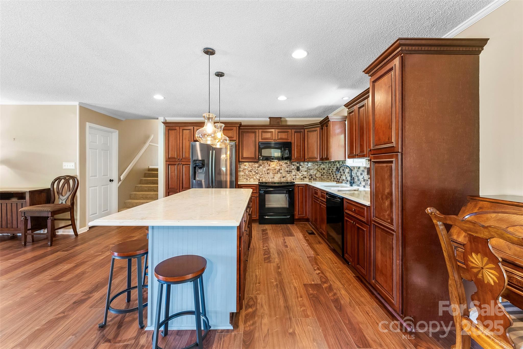 213 Press Sweezy Road Kings Mountain, NC 28086 - Photo 8 of 43 a large kitchen with stainless steel appliances kitchen island granite countertop a table chairs in it and a wooden floors
