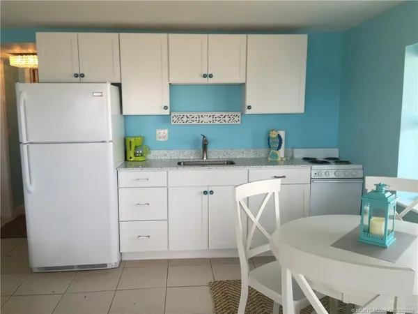 a kitchen with a white cabinets and white appliances