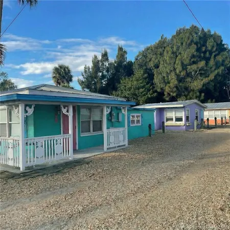 a view of a house with a yard and plants