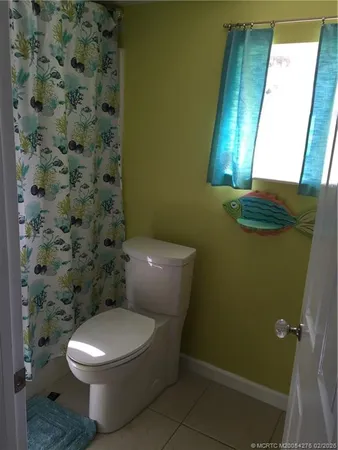 a white toilet sitting next to a small sink