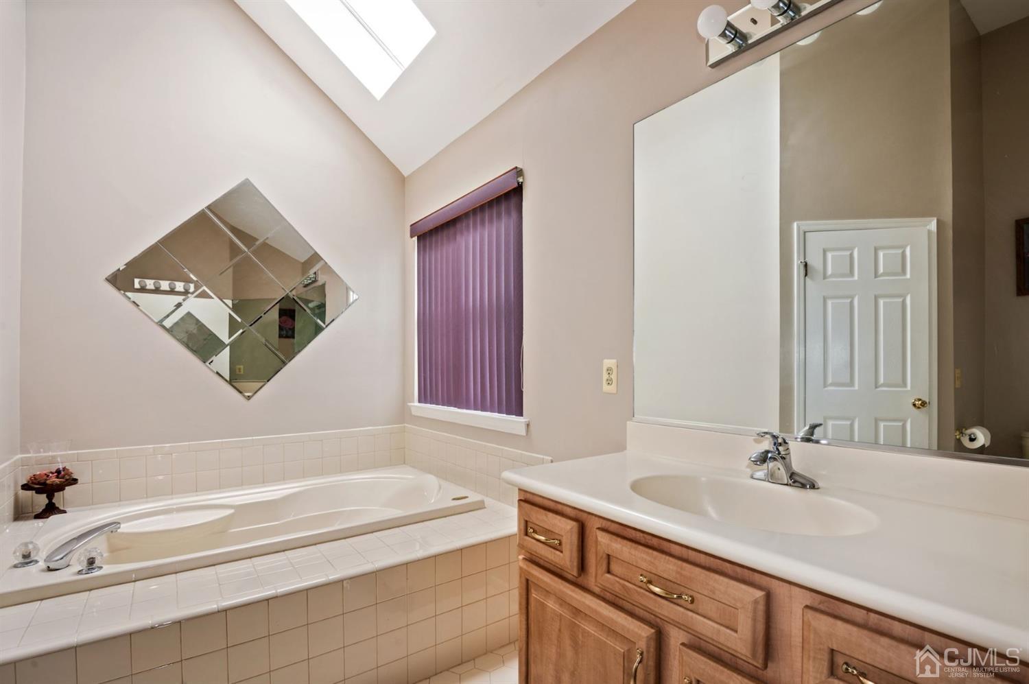 30 Brandywine Drive Old Bridge, NJ 07747 - Photo 16 of 39 a bathroom with a tub sink and mirror